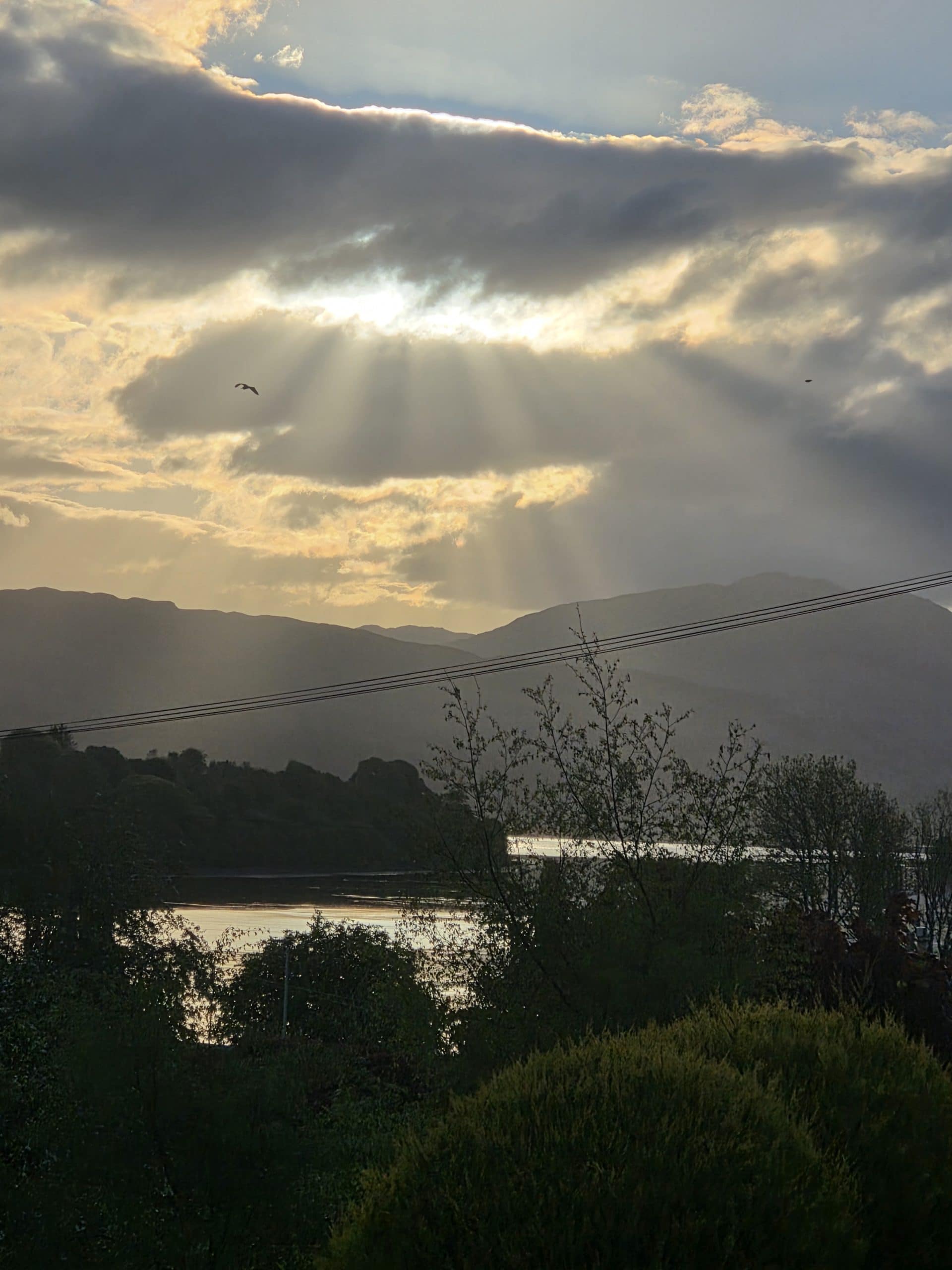 The rays of the sun during a sunrise over Loch Etive